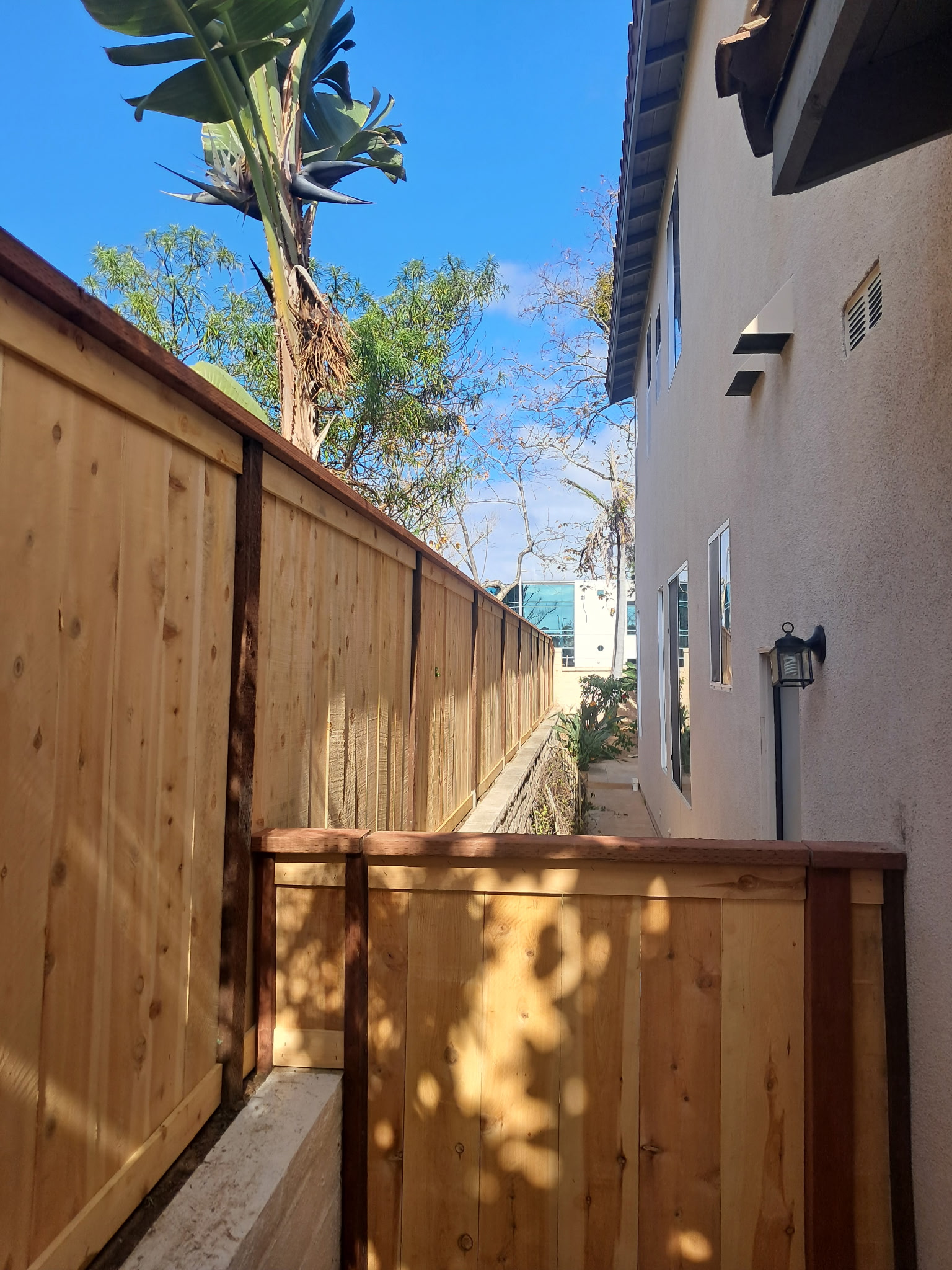 Wood privacy fence installed along a residential side yard in San Diego County