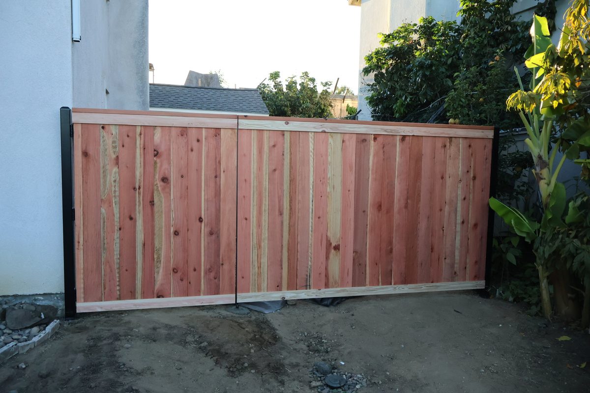Double cedar wood gate with black iron frame installation Oceanside CA - Top Class Fence